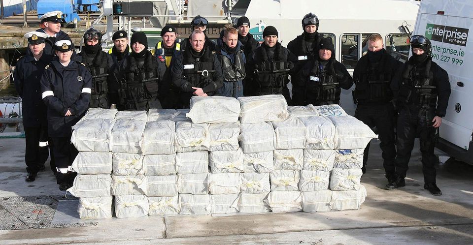 Armed Naval and Garda personnel with the half a billion euro of cocaine which was seized from a yacht off the west coast of Ireland